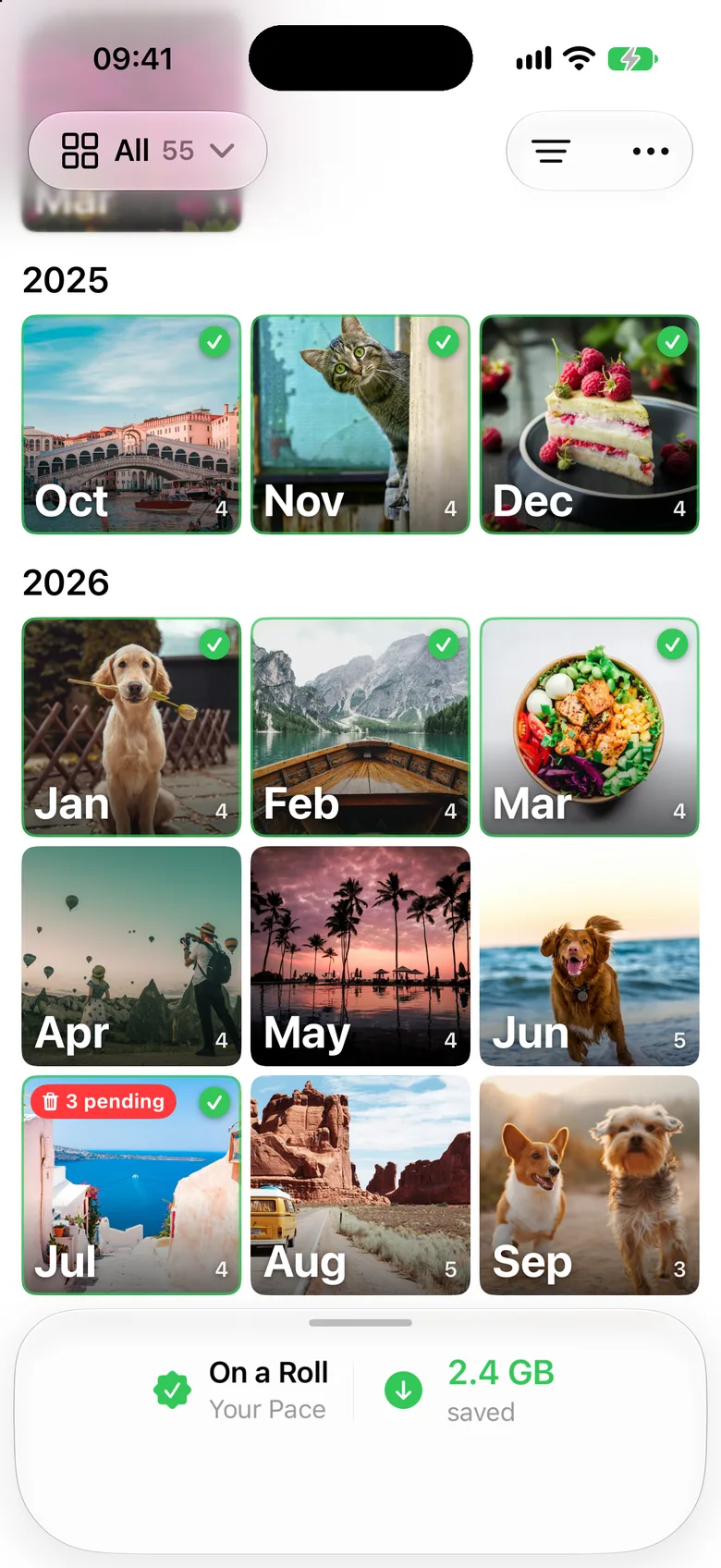 The Months screen: a grid of months with photo covers, finished months ticked green, and a card at the bottom saying On a Roll and 2.4 GB saved